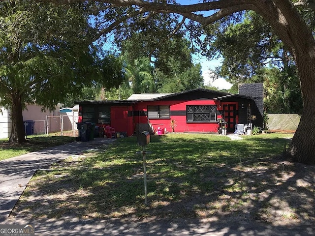 4407 W Price Ave, Tampa, FL 33611 - view of front of house with a chimney and concrete driveway