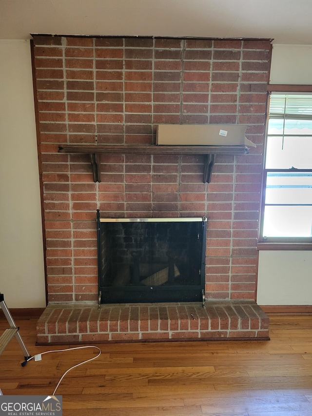 432 Northcrest Dr, Winder, GA 30680 - detailed view of wood finished floors, a brick fireplace, and baseboards