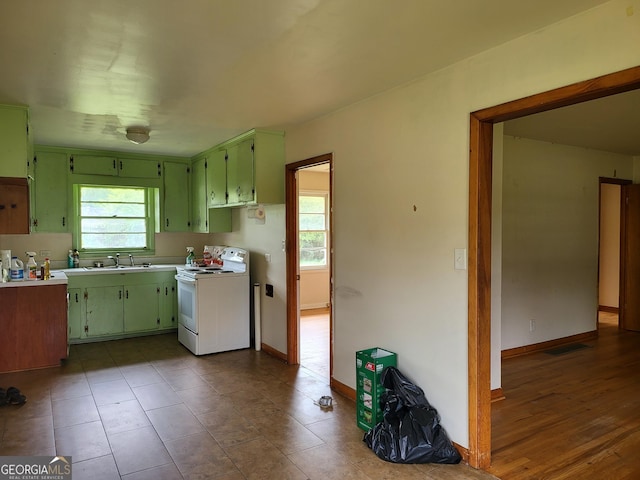 432 Northcrest Dr, Winder, GA 30680 - kitchen featuring white range with electric stovetop, green cabinets, light countertops, and baseboards