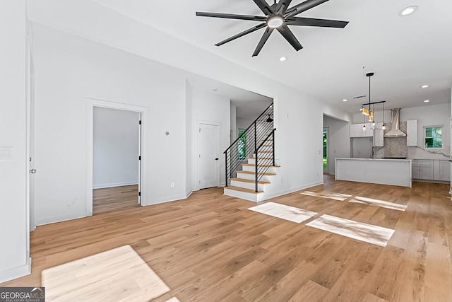 1835 Taylor Ave, East Point, GA 30344 - unfurnished living room featuring light wood-style flooring, ceiling fan, recessed lighting, stairway, and baseboards