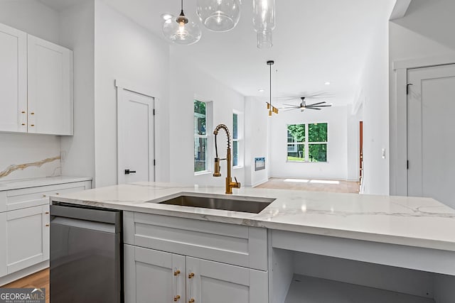 1835 Taylor Ave, East Point, GA 30344 - kitchen with stainless steel dishwasher, a sink, light stone countertops, wood finished floors, and hanging light fixtures