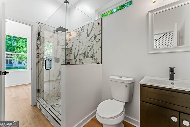 1835 Taylor Ave, East Point, GA 30344 - bathroom featuring a marble finish shower, toilet, vanity, wood finished floors, and baseboards