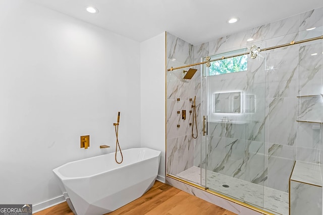 1835 Taylor Ave, East Point, GA 30344 - bathroom with wood finished floors, a marble finish shower, a freestanding bath, and recessed lighting
