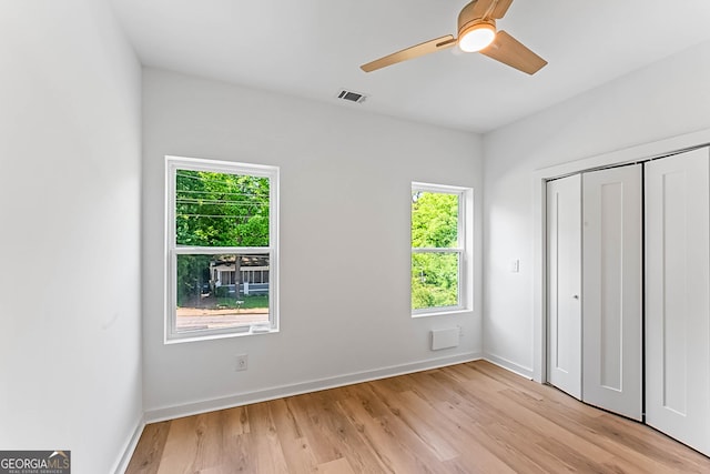 1835 Taylor Ave, East Point, GA 30344 - unfurnished bedroom with multiple windows, light wood-style flooring, a closet, and baseboards