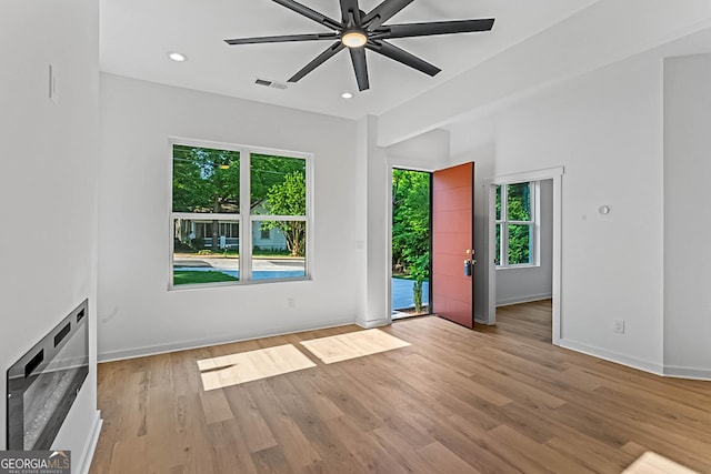 1835 Taylor Ave, East Point, GA 30344 - unfurnished living room with healthy amount of natural light, light wood-type flooring, a ceiling fan, baseboards, and recessed lighting