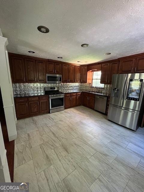 1221 Martin Nash Rd SW, Lilburn, GA 30047 - kitchen with stainless steel appliances, dark countertops, a sink, backsplash, and recessed lighting