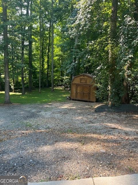 1221 Martin Nash Rd SW, Lilburn, GA 30047 - view of yard featuring a storage shed and an outdoor structure