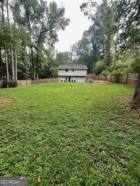 1221 Martin Nash Rd SW, Lilburn, GA 30047 - view of yard featuring view of wooded area