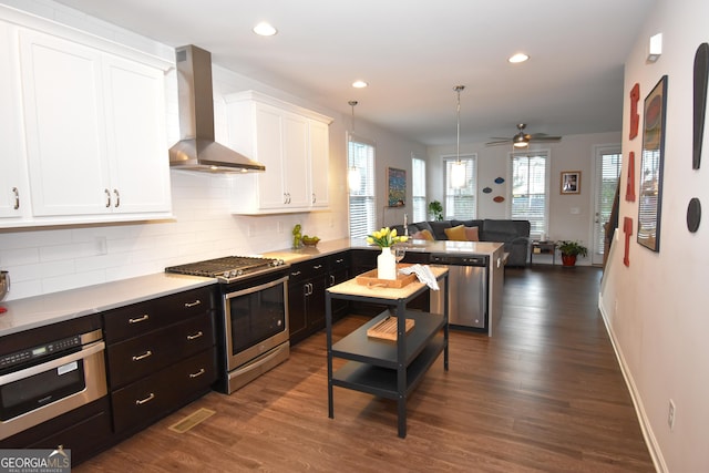 756 Cady Way, Atlanta, GA 30312 - kitchen featuring wall chimney exhaust hood, stainless steel appliances, white cabinetry, tasteful backsplash, and recessed lighting