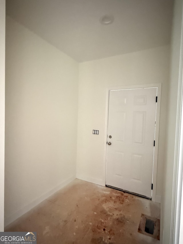 unfurnished room with unfinished concrete floors