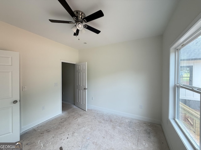 unfurnished room with baseboards and ceiling fan