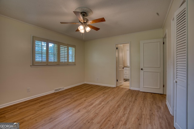 12 Riverview Rd SE, Rome, GA 30161 - unfurnished bedroom with light wood-type flooring, ornamental molding, a textured ceiling, baseboards, and connected bathroom