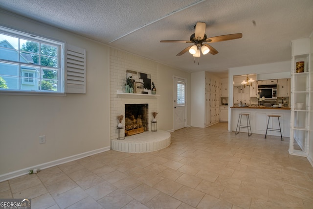 12 Riverview Rd SE, Rome, GA 30161 - unfurnished living room featuring a brick fireplace, a textured ceiling, a chandelier, ceiling fan, and baseboards