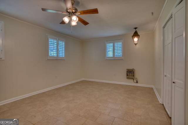 12 Riverview Rd SE, Rome, GA 30161 - empty room featuring a ceiling fan, heating unit, crown molding, and baseboards