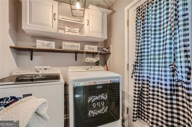 laundry room featuring cabinet space and washing machine and dryer