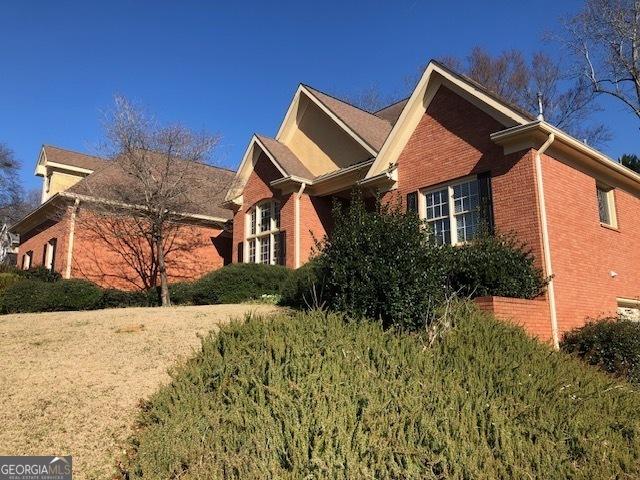 view of side of property with brick siding