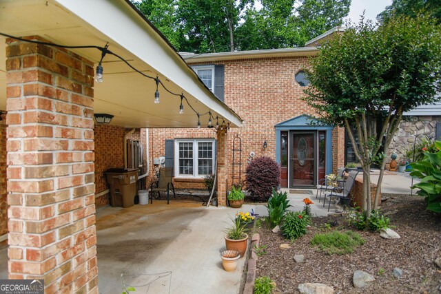 6500 Gaines Ferry Rd Unit G2, Flowery Branch, GA 30542 - property entrance with brick siding and a patio
