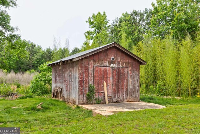 view of shed featuring a view of trees