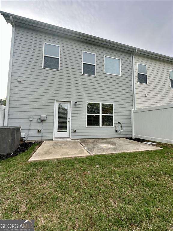 rear view of property with central AC and a patio