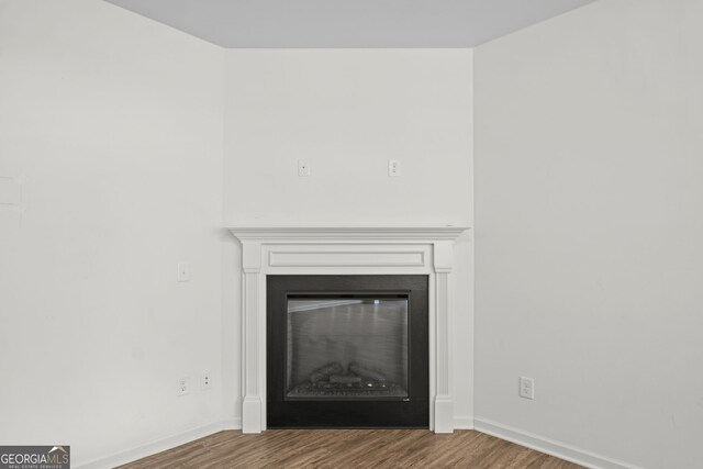 235 Centennial Cir, Canton, GA 30114 - unfurnished living room with wood finished floors, a ceiling fan, a glass covered fireplace, and baseboards