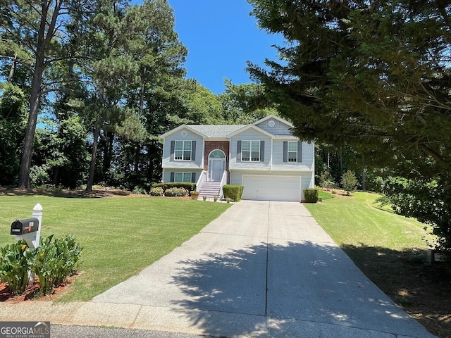 397 E Sycamore Dr, Winder, GA 30680 - split foyer home with driveway, a front lawn, and a garage