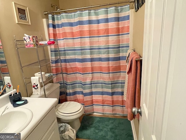 397 E Sycamore Dr, Winder, GA 30680 - bathroom with vanity, toilet, and a shower with shower curtain