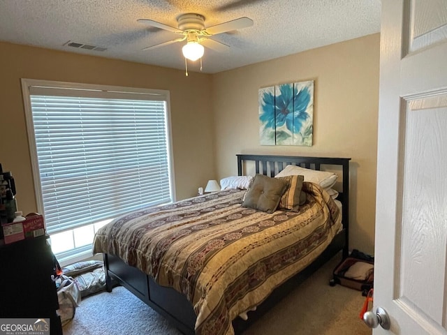 397 E Sycamore Dr, Winder, GA 30680 - bedroom with carpet, a textured ceiling, and ceiling fan