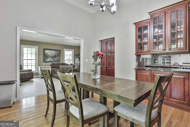 109 Cannon Rd, Sharpsburg, GA 30277 - dining room featuring a chandelier, high vaulted ceiling, and light wood-style flooring