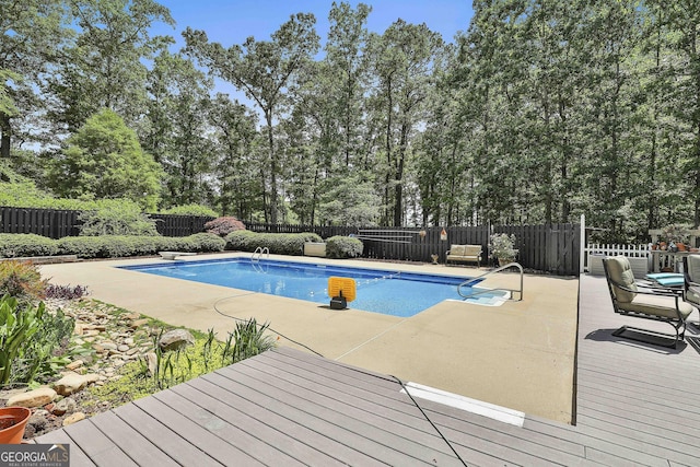109 Cannon Rd, Sharpsburg, GA 30277 - view of swimming pool with a fenced backyard, a wooden deck, a patio area, and view of scattered trees