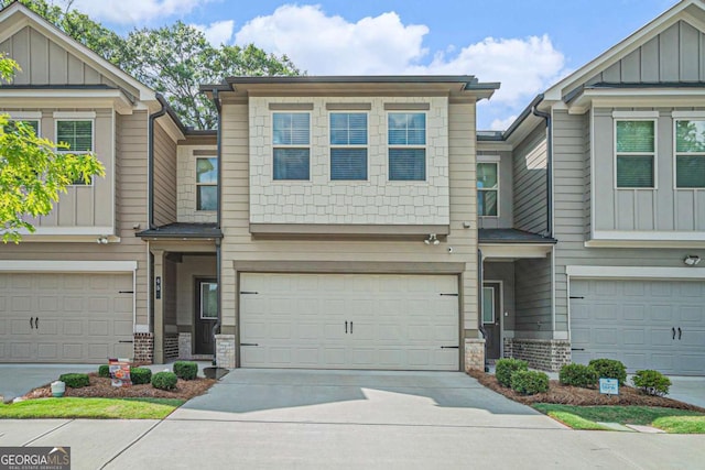 450 Rockfern Ct, Lilburn, GA 30047 - view of front of property with board and batten siding, an attached garage, and concrete driveway