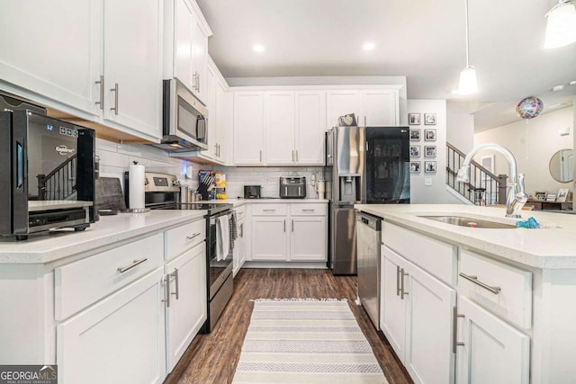 450 Rockfern Ct, Lilburn, GA 30047 - kitchen featuring stainless steel appliances, a sink, white cabinets, and recessed lighting