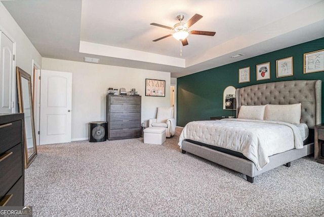 450 Rockfern Ct, Lilburn, GA 30047 - carpeted bedroom with a tray ceiling, ceiling fan, and baseboards