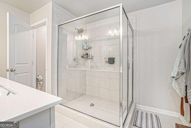 450 Rockfern Ct, Lilburn, GA 30047 - full bath featuring tile patterned flooring, a shower stall, vanity, and baseboards