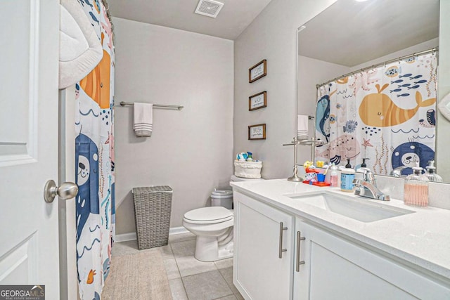 450 Rockfern Ct, Lilburn, GA 30047 - bathroom featuring toilet, tile patterned floors, vanity, and baseboards