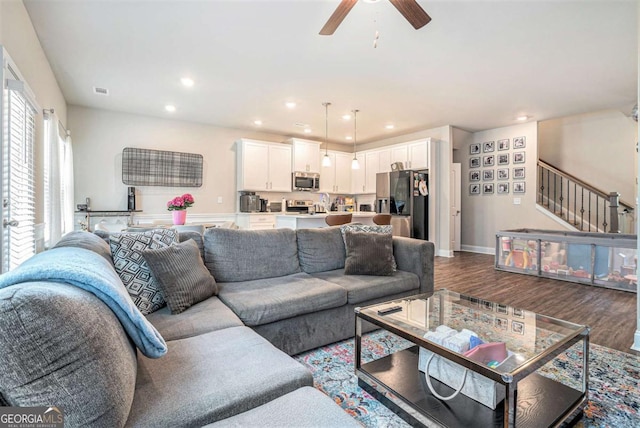 450 Rockfern Ct, Lilburn, GA 30047 - living room with dark wood-style floors, stairway, ceiling fan, and recessed lighting