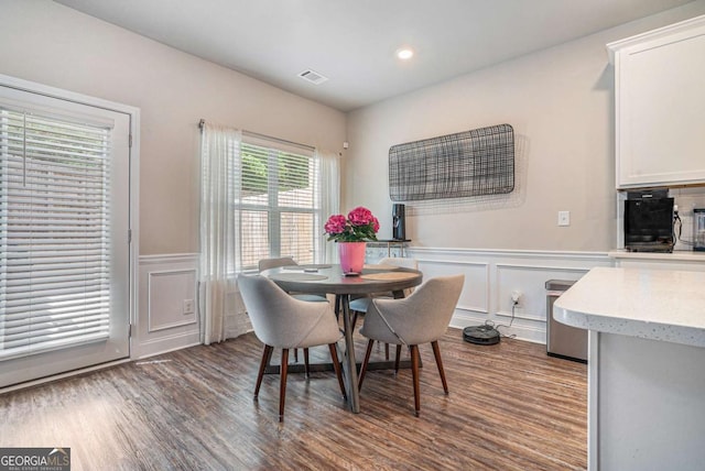 450 Rockfern Ct, Lilburn, GA 30047 - dining space featuring a decorative wall, dark wood finished floors, a wainscoted wall, and recessed lighting