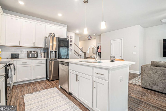450 Rockfern Ct, Lilburn, GA 30047 - kitchen with appliances with stainless steel finishes, a sink, open floor plan, white cabinets, and dark wood-style flooring