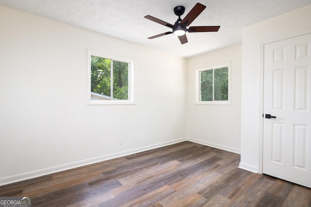 754 Wright Dr, Columbus, GA 31907 - unfurnished bedroom featuring multiple windows, dark wood finished floors, and a ceiling fan