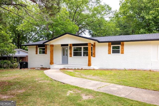 754 Wright Dr, Columbus, GA 31907 - view of front facade featuring brick siding, a porch, a front lawn, and crawl space