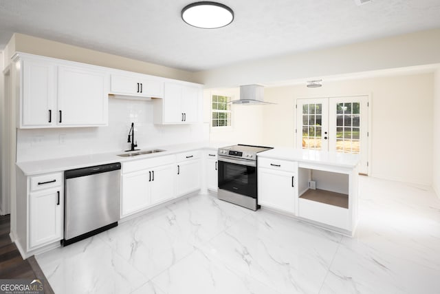 754 Wright Dr, Columbus, GA 31907 - kitchen featuring appliances with stainless steel finishes, range hood, a peninsula, white cabinetry, and french doors