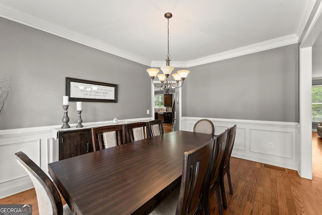 1050 Double Branches Ln, Dallas, GA 30132 - dining room featuring a chandelier, wood finished floors, crown molding, a wainscoted wall, and a decorative wall