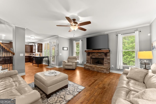 1050 Double Branches Ln, Dallas, GA 30132 - living area with stairway, plenty of natural light, a ceiling fan, a fireplace, and crown molding