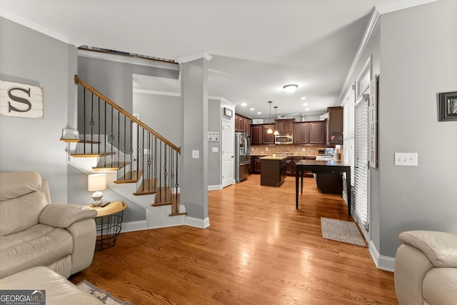 1050 Double Branches Ln, Dallas, GA 30132 - living area featuring light wood-style floors, recessed lighting, ornamental molding, baseboards, and stairs