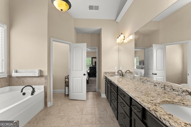 1050 Double Branches Ln, Dallas, GA 30132 - ensuite bathroom featuring double vanity, a garden tub, tile patterned floors, and baseboards