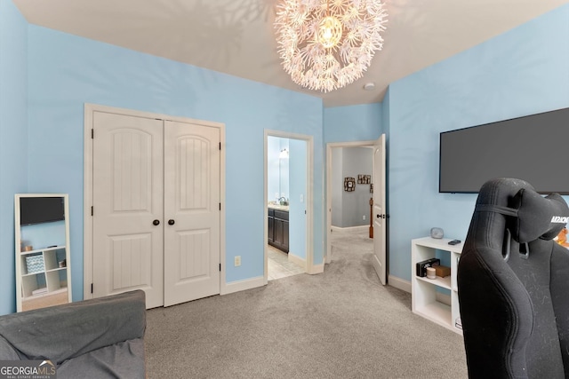 1050 Double Branches Ln, Dallas, GA 30132 - bedroom with a chandelier, light colored carpet, baseboards, a closet, and ensuite bathroom