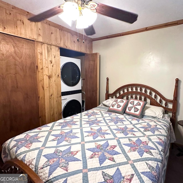 77 Hollow Log Path, Cleveland, GA 30528 - bedroom featuring stacked washer / drying machine, wood walls, ornamental molding, and ceiling fan