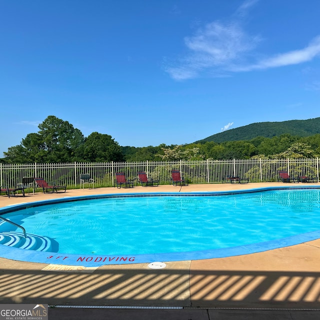 77 Hollow Log Path, Cleveland, GA 30528 - community pool featuring a mountain view, fence, and a patio