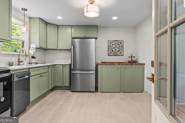 492 Clover St, Athens, GA 30606 - kitchen with green cabinetry, freestanding refrigerator, dishwasher, a sink, and tasteful backsplash