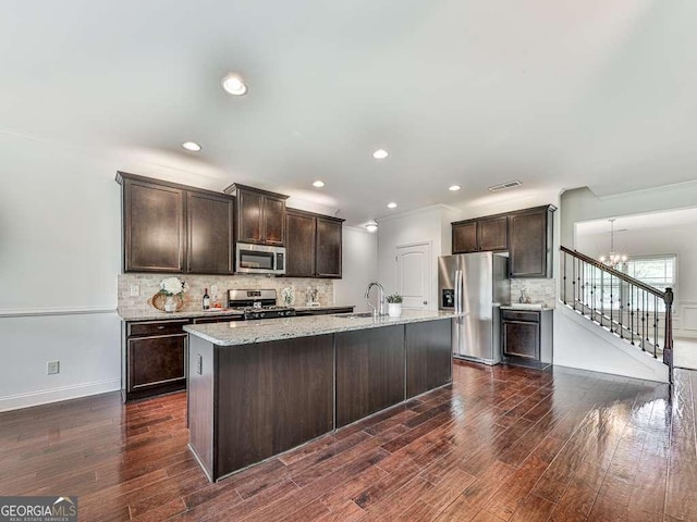 631 Naturewalk Blvd, Dallas, GA 30132 - kitchen with stainless steel appliances, dark brown cabinets, dark wood-type flooring, decorative backsplash, and recessed lighting