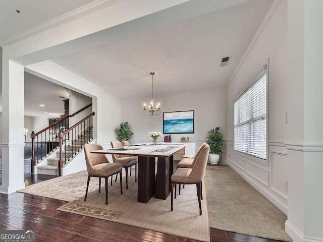631 Naturewalk Blvd, Dallas, GA 30132 - dining room with stairway, a chandelier, hardwood / wood-style floors, ornamental molding, and a wainscoted wall